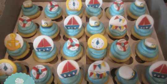 Fondant sail boat, compass, captains hat, bunting, lifesaver, sailing cupcakes